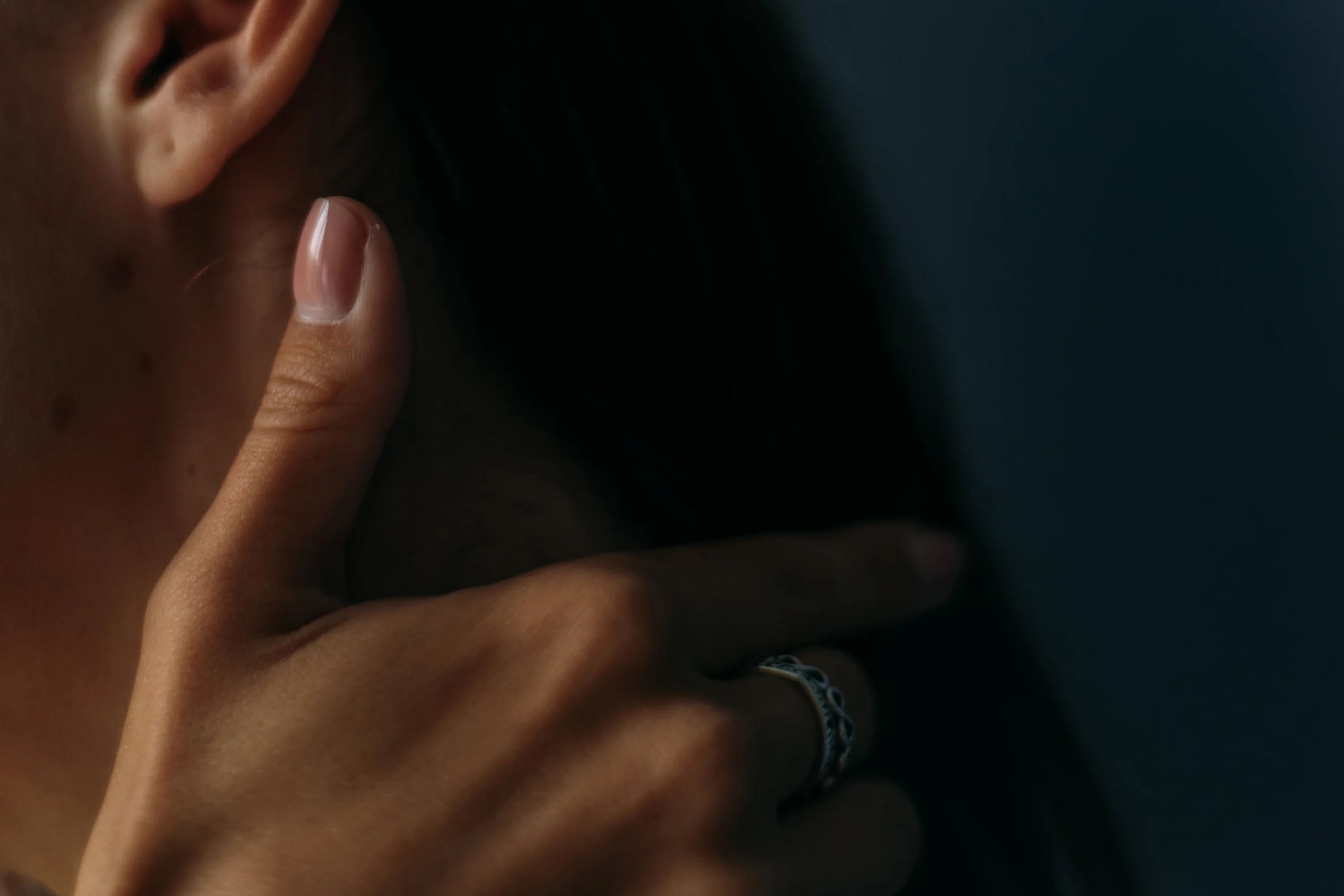 person's hand touching their neck